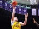 Basketball player in a yellow Tigers jersey leaps for a shot near the basket, NCAA banners visible in the arena.