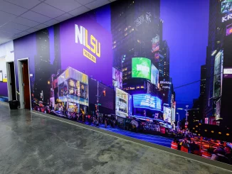 Long hallway with a wall-wide mural of a neon city at night, purple tones, bright billboards, and a McDonald's sign visible.