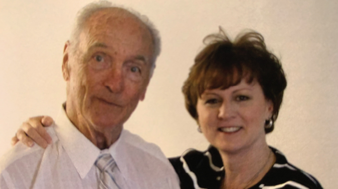 BunnieCannonBillyCannon1 | TigerRag.com An older man in a white shirt and striped tie stands beside a smiling woman, with his arm around her shoulder.