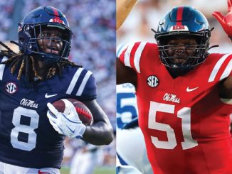 Two Ole Miss football players in action: left player in navy jersey #8 holding the ball, right player in red jersey #51 raising a hand for a tackle or celebration, both with SEC patches