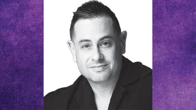 DanWolken_YahooSports | TigerRag.com Black-and-white headshot of a smiling man wearing a dark blazer, facing the camera.