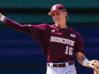 Baseball pitcher in a maroon Bobcats uniform throwing a ball, wearing a cap and glove.
