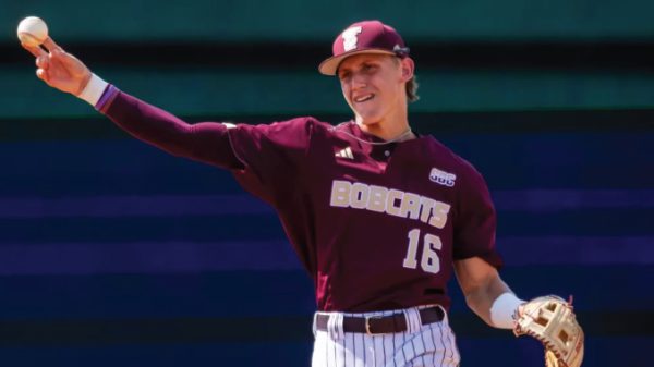 Baseball pitcher in a maroon Bobcats uniform throwing a ball, wearing a cap and glove.