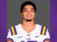 Athlete in LSU football jersey facing camera, gray background.