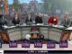ESPN College GameDay broadcast on a sunlit campus plaza, hosts seated at a curved desk with LSU branding while a large crowd holds colorful signs in the background.