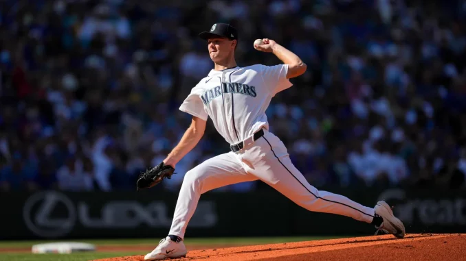 Seattle Mariners pitcher in a white uniform delivering a pitch on the mound during a game.