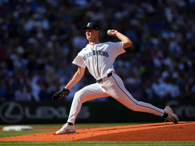 Seattle Mariners pitcher in a white uniform delivering a pitch on the mound during a game.