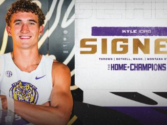 Portrait of a smiling college athlete in a white jersey posing beside a bold 'SIGNED' banner with 'The Home of Champions' text.