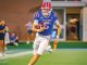 Bulldogs football player wearing number 5 runs with the ball on the field.