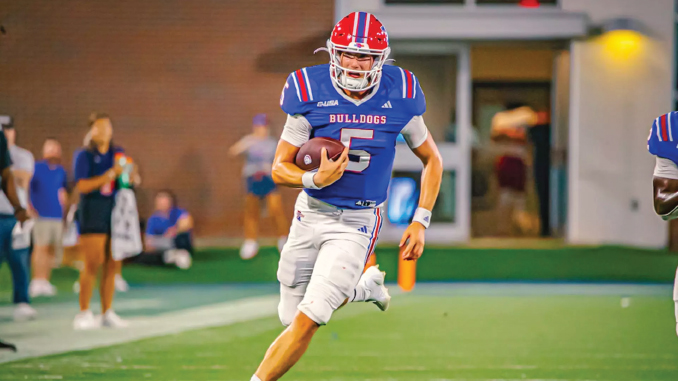 Bulldogs football player wearing number 5 runs with the ball on the field.