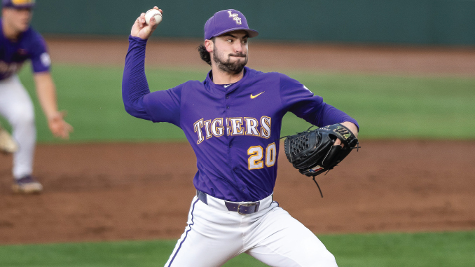 Right-handed baseball pitcher in a purple Tigers uniform (number 20) mid-pitch on the mound, glove on his left hand.