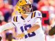 LSU quarterback in white jersey #10 and yellow helmet throwing a pass during a game.