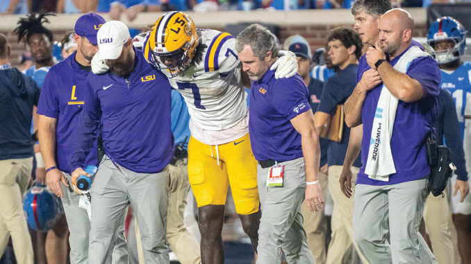 LSU tight end Trey'Dez Green is helped off the field with a knee injury in the fourth quarter at Ole Miss on Saturday night. (Tiger Rag photo by Michael Bacigalupi). 