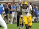 LSU #7 in white and gold races toward a defender, Franklin #5 in blue defends on a college football field.