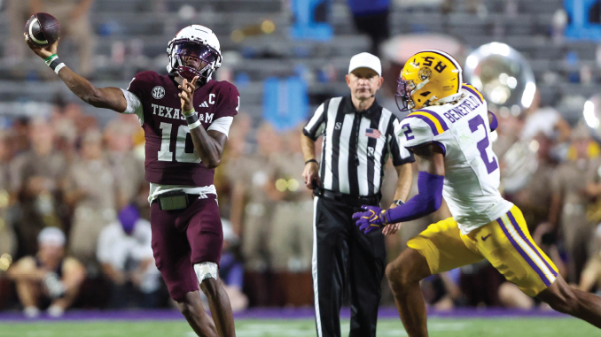 Texas A&M quarterback wearing maroon jersey throws a pass as LSU defender in white and yellow chases him, with a referee in the background.