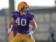LSU football player wearing purple jersey #40 and a yellow helmet, mid-action on a practice field.
