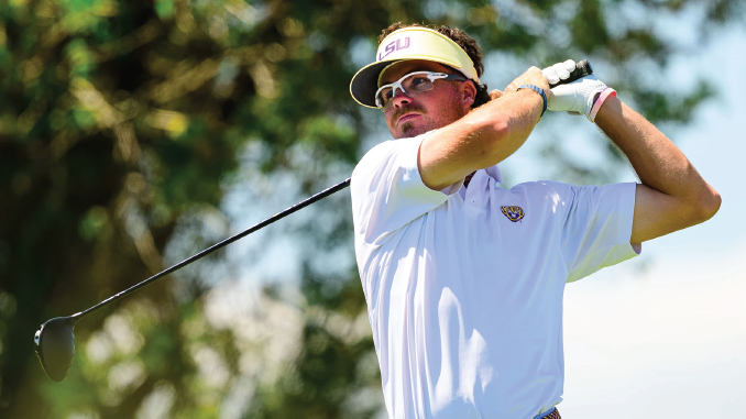 Golfer wearing an LSU visor and white polo mid-swing on a sunny golf course.