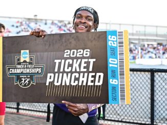 Smiling athlete holds a large mock ticket reading '2026 TICKET PUNCHED' at a track and field championships event.
