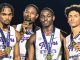 Four male college sprinters in white-and-purple Tigers uniforms pose with gold medals around their necks after an SEC championship, one biting a medal in the center-left.