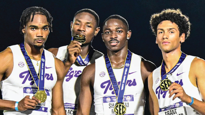 Four male college sprinters in white-and-purple Tigers uniforms pose with gold medals around their necks after an SEC championship, one biting a medal in the center-left.