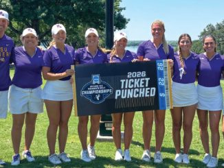 Eight LSU athletes in purple tops and white skirts pose on a sunny grassy field, holding a banner that reads '2026 Ticket Punched'.