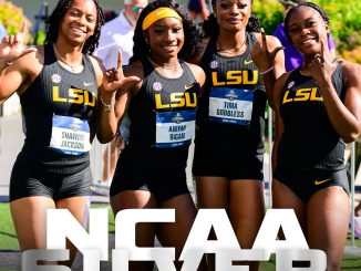 Four LSU women track athletes posing together at the NCAA Outdoor Track & Field Championships, wearing black and yellow LSU uniforms.