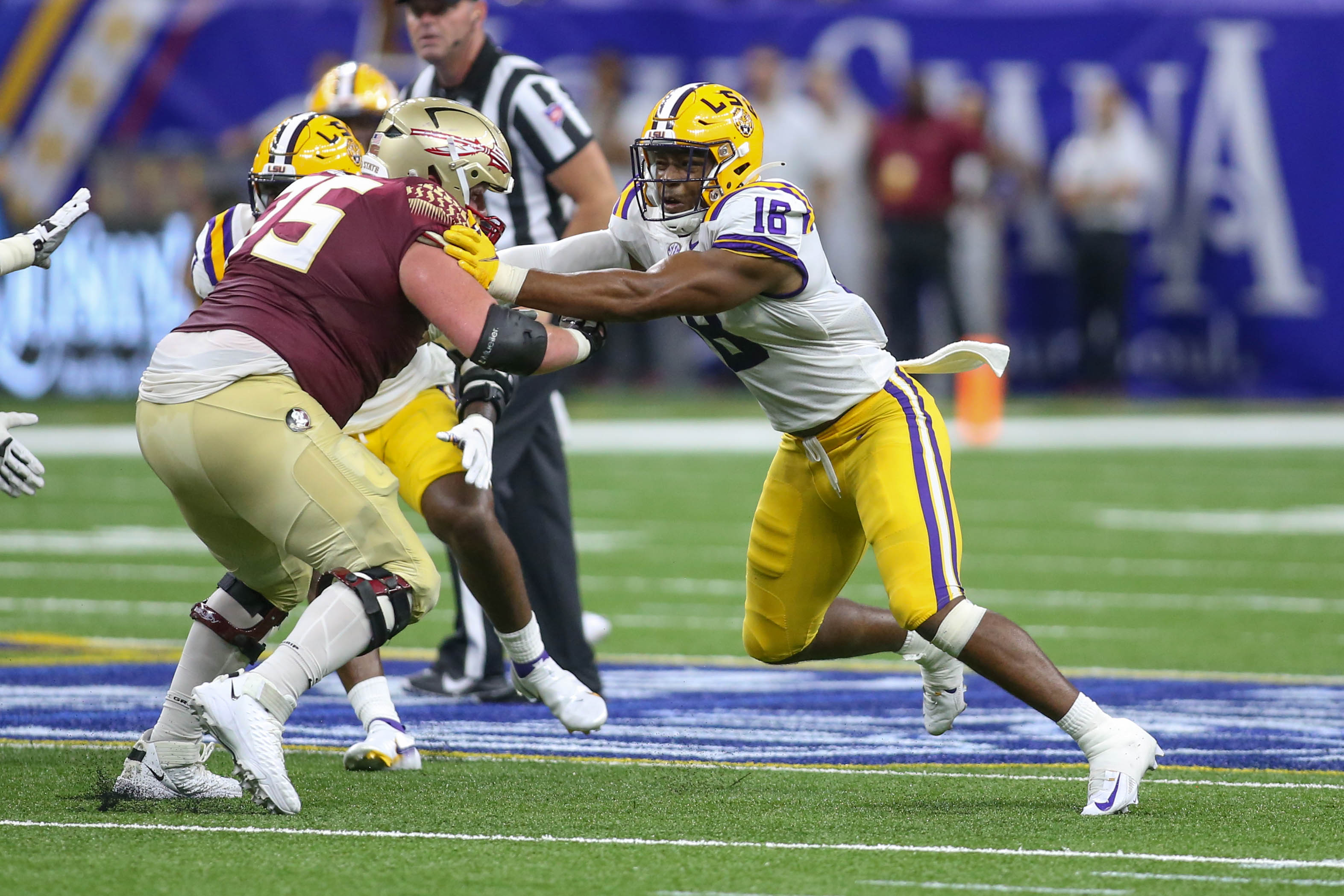LSU's BJ Ojulari (18) rushes the passer.
