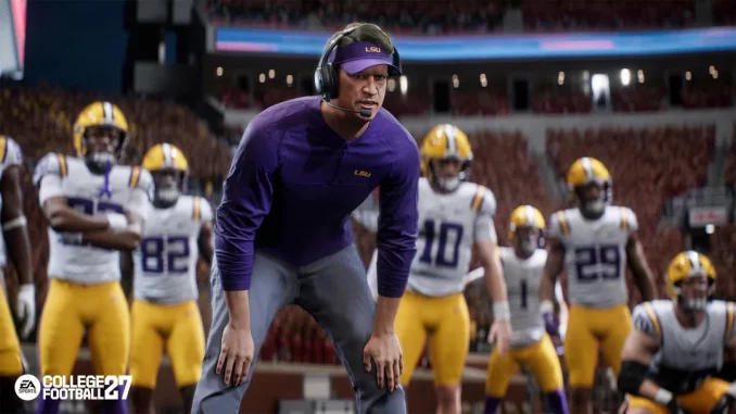 LSU football coach in a purple shirt and headset crouches on the field, surrounded by players in white and yellow uniforms during a game.