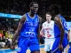 Italy basketball players in blue jerseys celebrate on court during a game, one shouting with fist clenched.