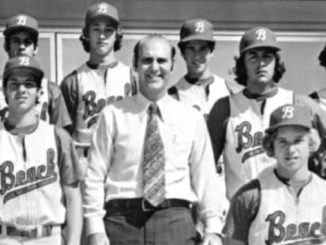 Black-and-white photo of a baseball team posing with their coach in a shirt and tie; players wear matching uniforms with B logos.