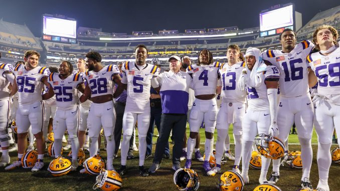 Trey Holly (25) celebrates Army win with teammates following his first TD as a Tiger