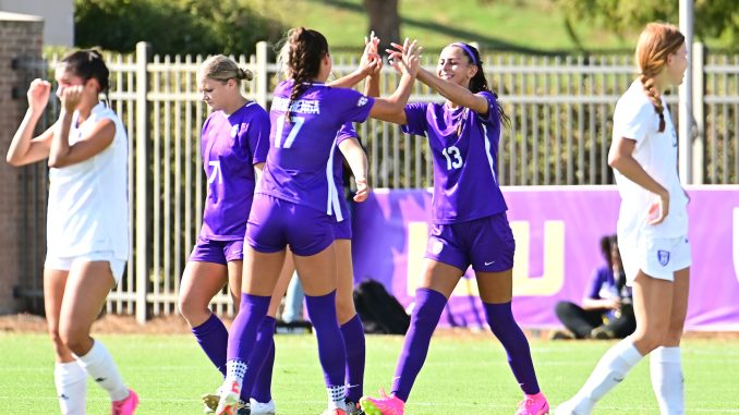 Taylor Dobles 13 receives congratulations after a goal from Caley Swierenga 17
