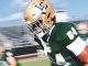 LSU football player in green jersey #81 running on a sunny game field, gold helmet and white gloves visible.