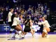 LSU women's basketball players celebrate on the court as fans cheer in the stands.