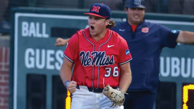 Ole Miss softball player in red uniform #36 on the mound celebrating with glove, cheering loudly.