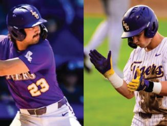 Two LSU Tigers baseball players: a batter in purple swings on the left, and a player in white pinstripes with a purple helmet on the right.